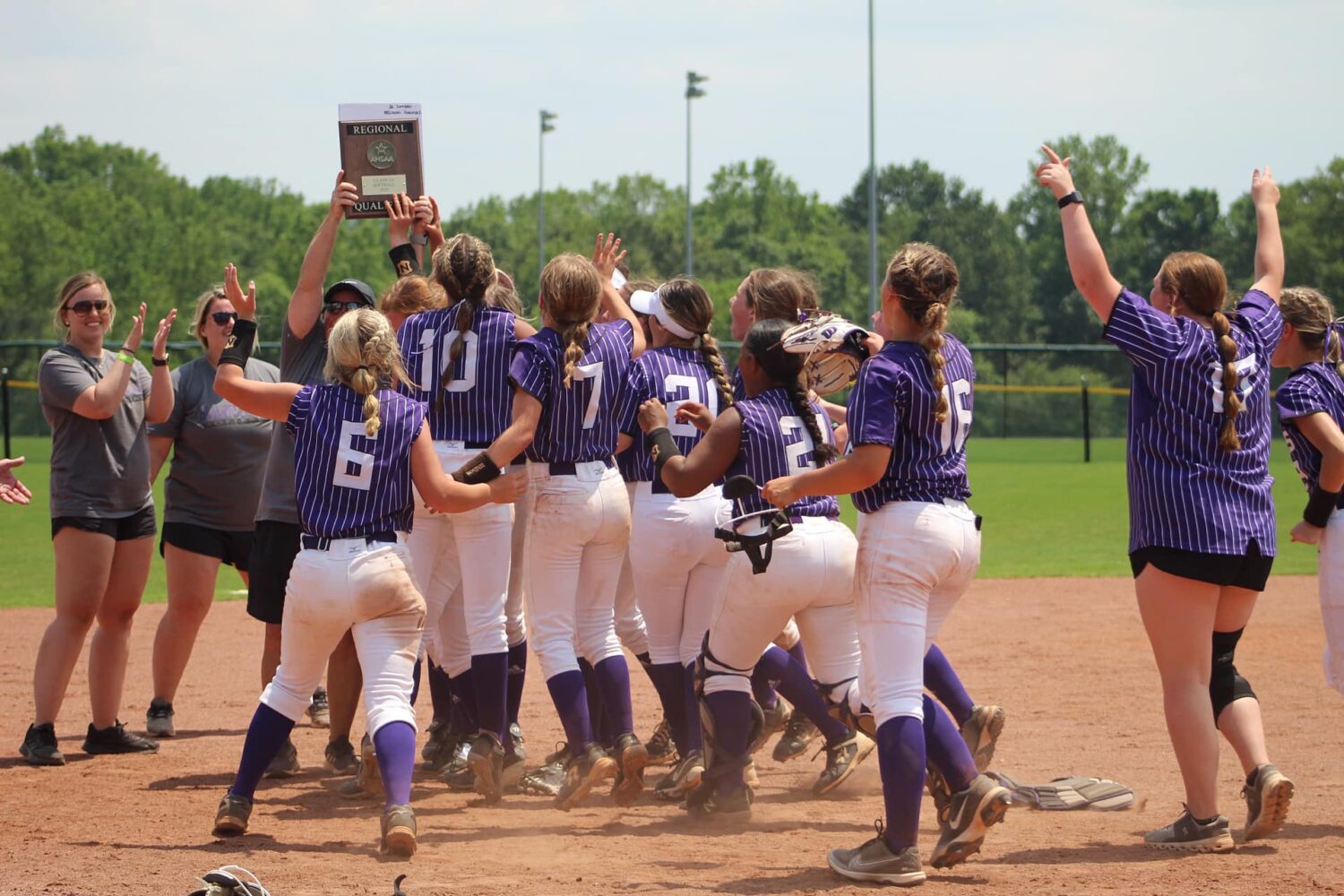 The Danville Lady Hawks mob their coach, Christy Ferguson, after winning the 3A North Regional after a 7-5 over Mars Hill. Photo by Bridgette Guest