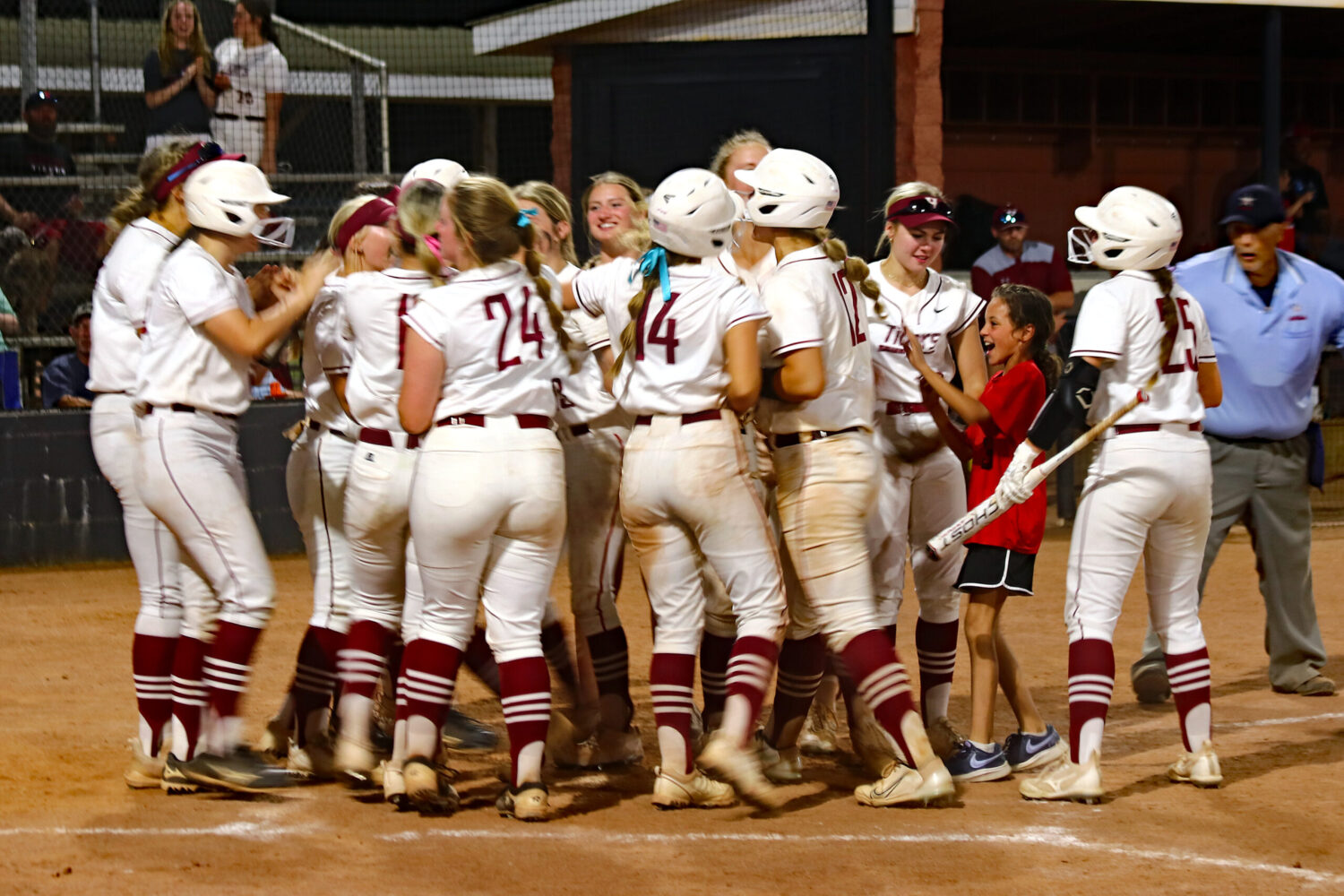 Hartselle players celebrate Katie Norgard’s second home run of the game, a three-run shot that gave the Tigers an 11-10 lead in the bottom of the sixth inning of the Tigers’ 13-10 victory over Athens. Photo by Jim Meadows 