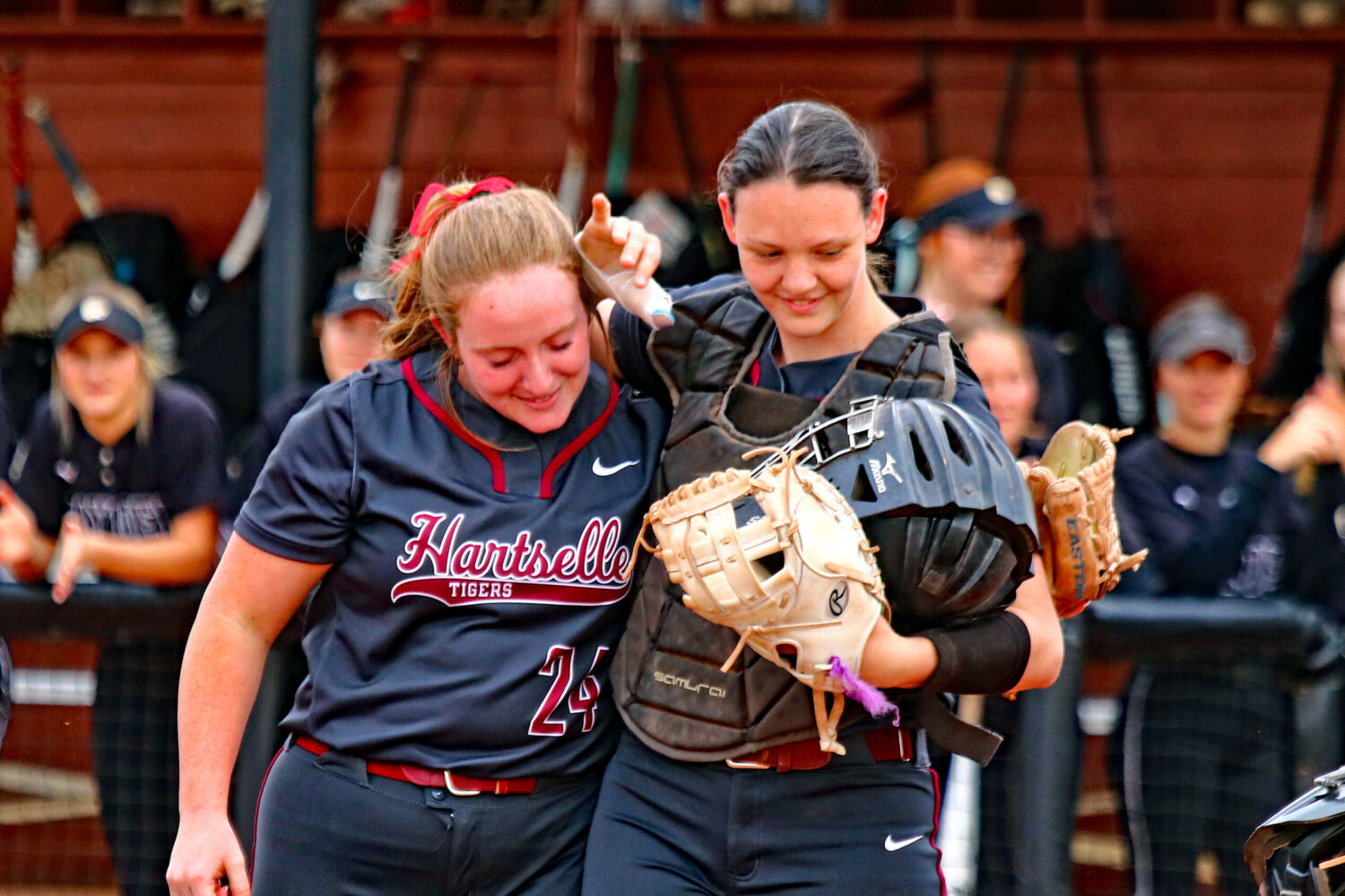 Seniors Sarah Bowling and Aly Putnam embrace following the first pitch of the Tigers game with Hayden. Photo by Jim Meadows