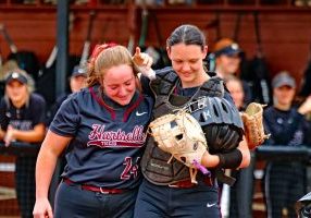 Seniors Sarah Bowling and Aly Putnam embrace following the first pitch of the Tigers game with Hayden. Photo by Jim Meadows